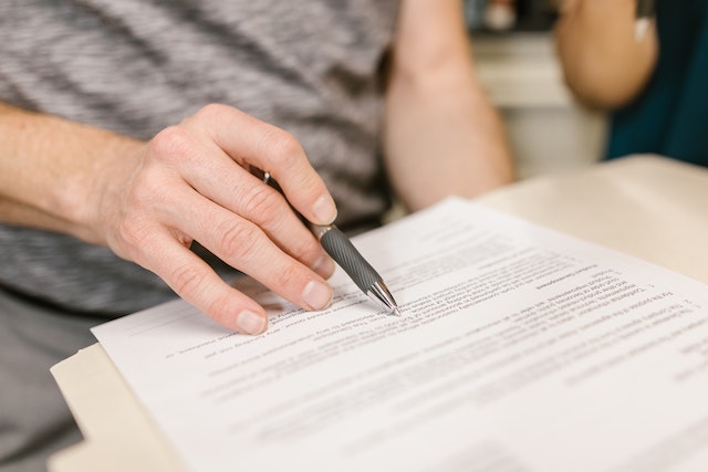 person writing lease agreement